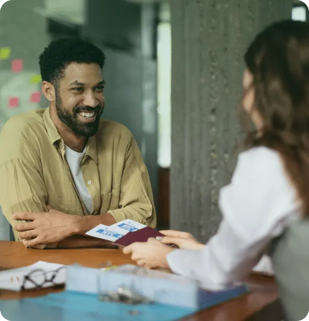 Man smiling during a consultation about SBA MicroLoans with a business advisor in North Carolina.